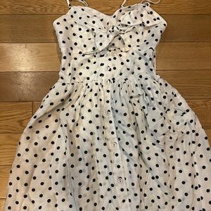White polka dot pin up dress with bow and peep hole in front.